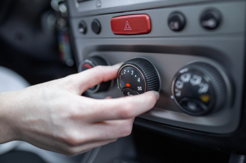 woman hand turning car air conditioning system car air conditioner off button close up view